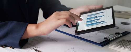 Women working in office. financial analysis with charts on pad for business, accounting, insurance or finance concept